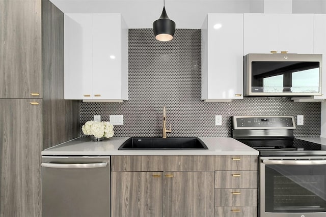 4361 S Congress Ave Unit 333, Austin, TX 78745 - kitchen featuring appliances with stainless steel finishes, modern cabinets, and white cabinetry