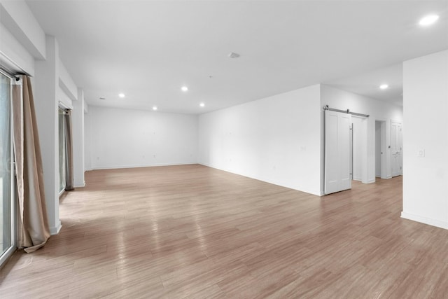 4361 S Congress Ave Unit 333, Austin, TX 78745 - unfurnished room featuring a barn door, recessed lighting, and light wood finished floors