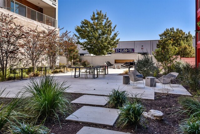 view of home's community with a patio area