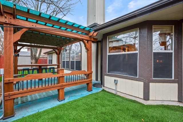 wooden terrace featuring a lawn