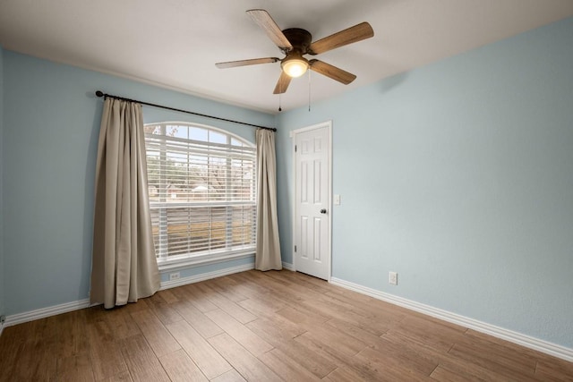 spare room featuring light hardwood / wood-style flooring and ceiling fan