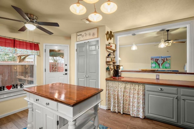 kitchen featuring pendant lighting, wood counters, and dark hardwood / wood-style flooring