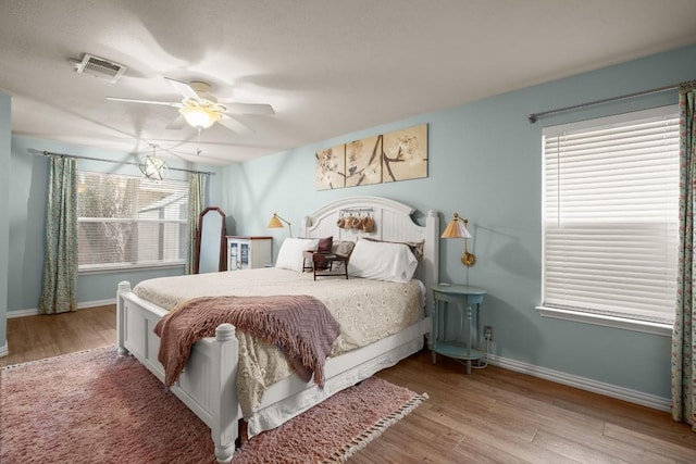 bedroom with ceiling fan and light hardwood / wood-style floors