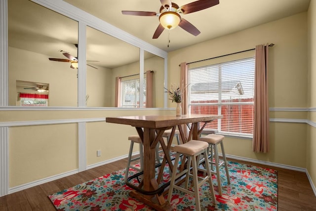 dining space with dark hardwood / wood-style floors