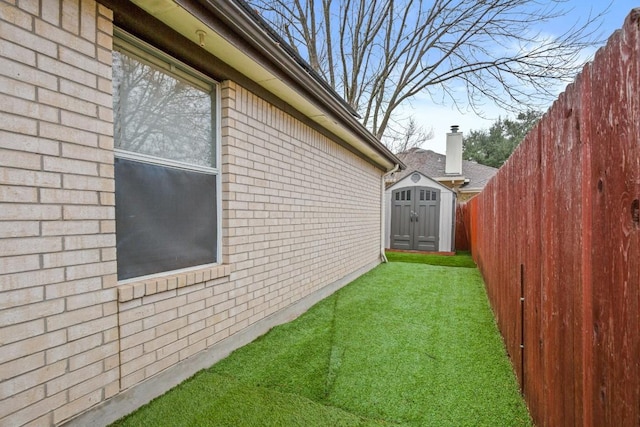 view of home's exterior with a yard and a storage shed