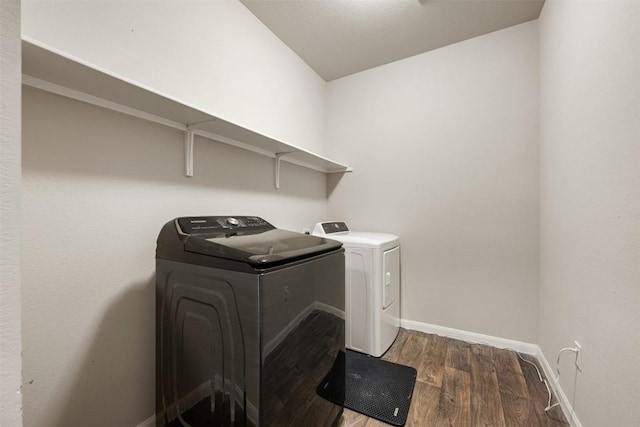 laundry room featuring dark wood-type flooring and independent washer and dryer