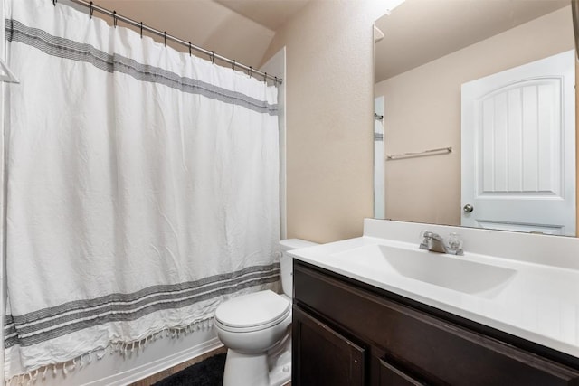 bathroom with vanity, toilet, and walk in shower