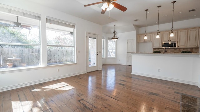 interior space with ceiling fan and dark hardwood / wood-style floors