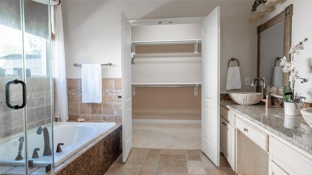 bathroom featuring vanity and shower with separate bathtub