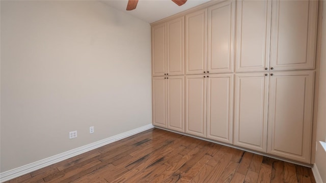 unfurnished bedroom featuring hardwood / wood-style flooring and ceiling fan