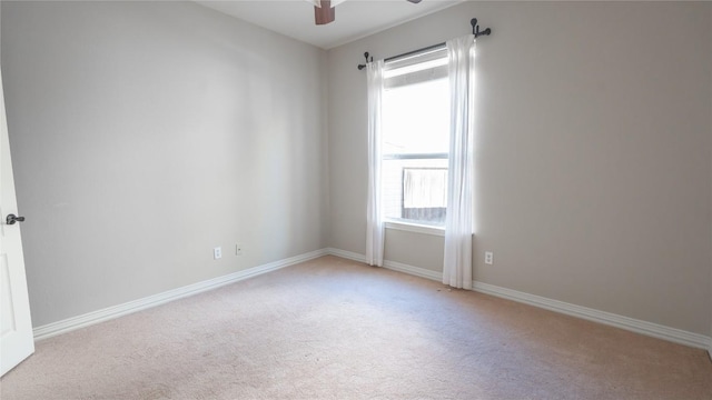 carpeted empty room featuring ceiling fan