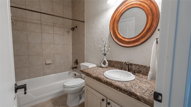 full bathroom with vanity, toilet, tiled shower / bath combo, and tile patterned flooring