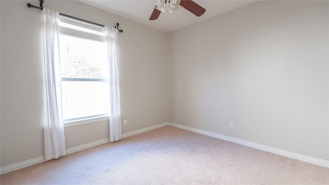 carpeted spare room with ceiling fan