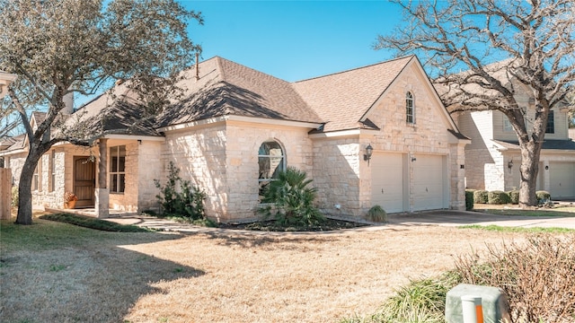 view of front of home with a garage and a front lawn