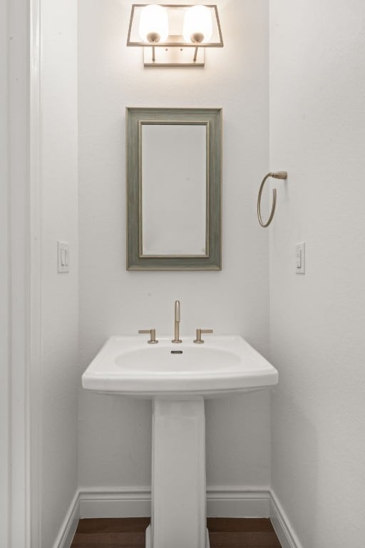 5 Crystal Springs Ct Unit A, The Hills, TX 78738 - bathroom featuring baseboards, a sink, and wood finished floors