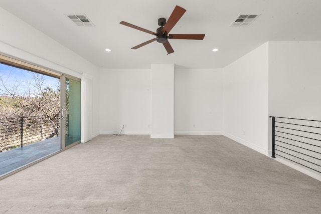 spare room with light colored carpet and ceiling fan