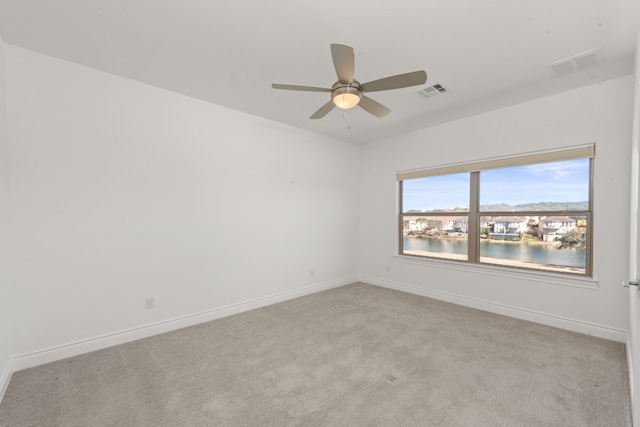 5 Crystal Springs Ct Unit A, The Hills, TX 78738 - spare room with light colored carpet, baseboards, a ceiling fan, and a water view