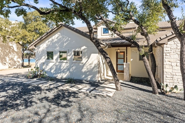 5 Crystal Springs Ct Unit A, The Hills, TX 78738 - view of front of home featuring stucco siding and stone siding