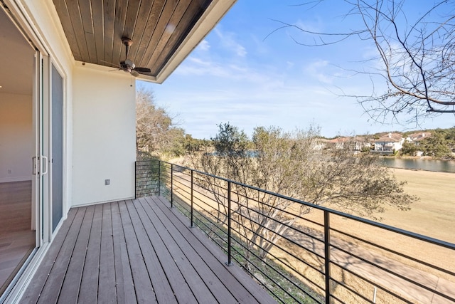 balcony with a water view and ceiling fan