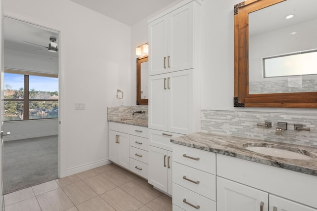 bathroom with vanity, tile patterned floors, ceiling fan, and decorative backsplash