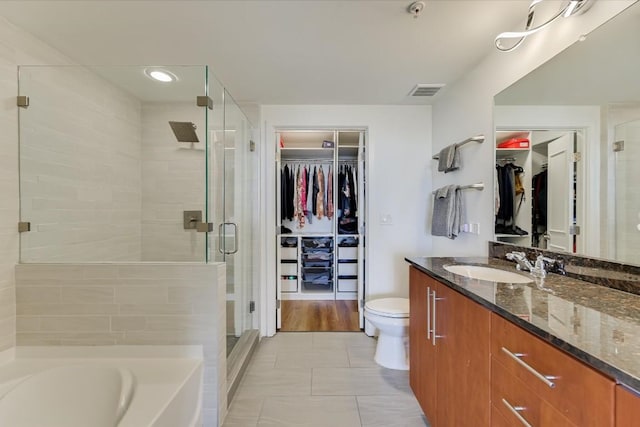 full bathroom featuring vanity, tile patterned flooring, independent shower and bath, and toilet