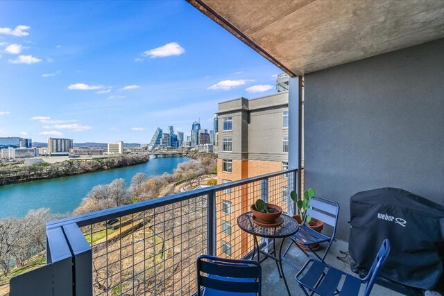 balcony featuring a water view and area for grilling