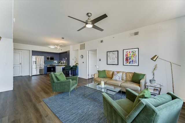 living room with ceiling fan and dark hardwood / wood-style floors