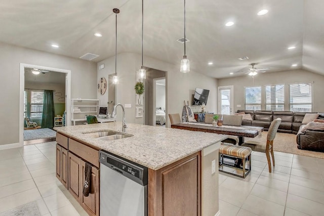 kitchen featuring light tile patterned flooring, sink, decorative light fixtures, a center island with sink, and dishwasher