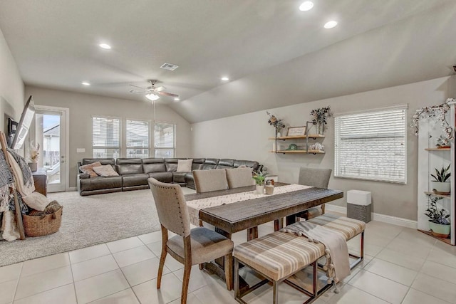 dining area with ceiling fan, lofted ceiling, light tile patterned floors, and a wealth of natural light