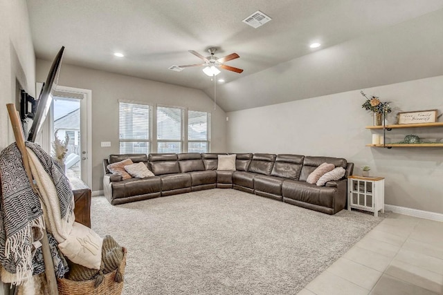 living room featuring lofted ceiling, ceiling fan, and light tile patterned flooring