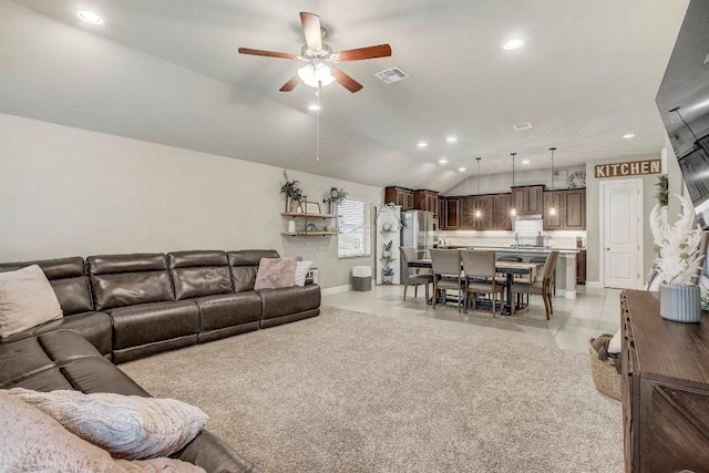 living room featuring lofted ceiling, light tile patterned floors, and ceiling fan