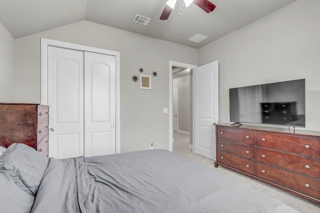 bedroom featuring ceiling fan, lofted ceiling, light carpet, and a closet