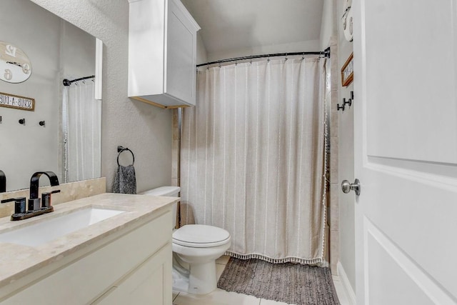 bathroom with tile patterned floors, vanity, and toilet