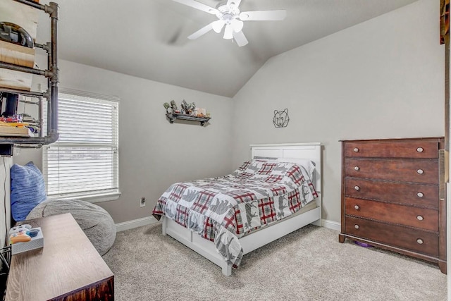 bedroom with vaulted ceiling, light colored carpet, and ceiling fan