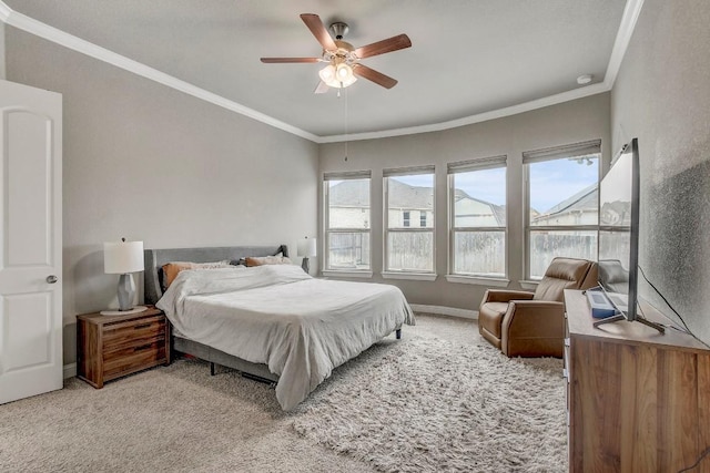 carpeted bedroom with crown molding and ceiling fan