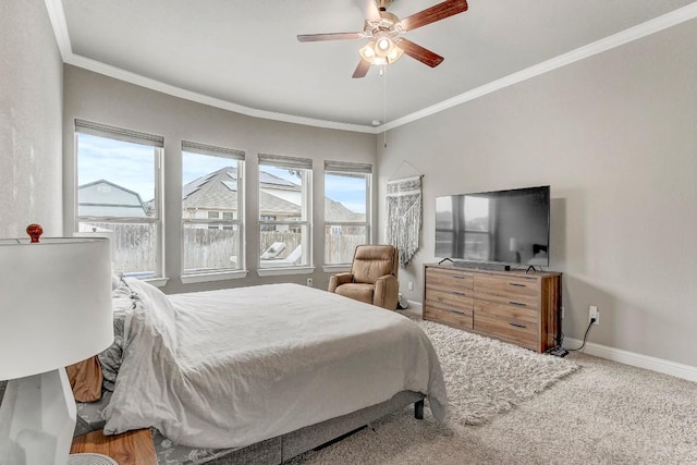 bedroom with ceiling fan, ornamental molding, carpet, and multiple windows