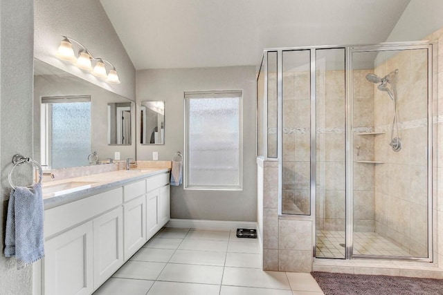 bathroom with vanity, a healthy amount of sunlight, tile patterned floors, and a shower with shower door