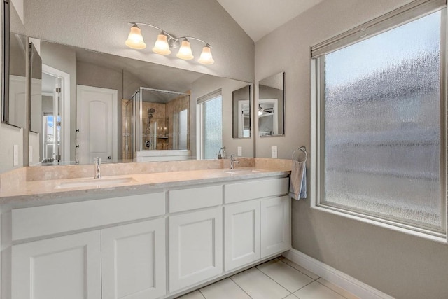 bathroom with tile patterned flooring, vanity, and a shower with shower door