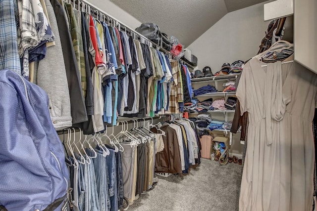 spacious closet featuring lofted ceiling and carpet floors