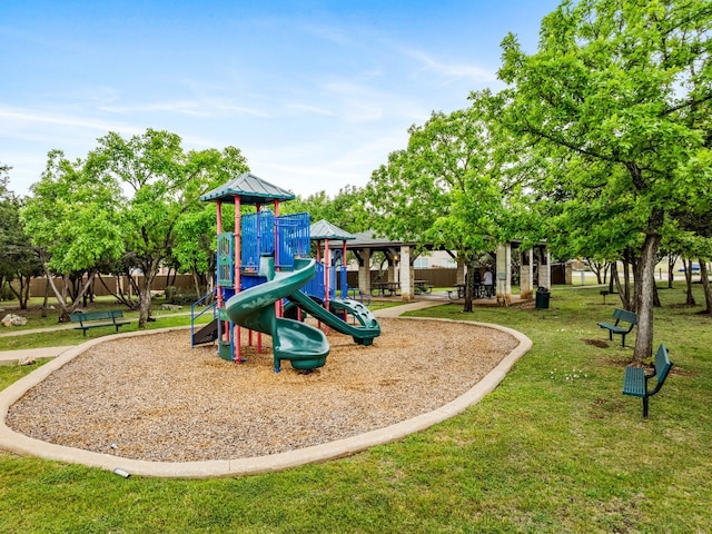 view of playground with a lawn