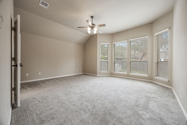 interior space with carpet floors, ceiling fan, and vaulted ceiling