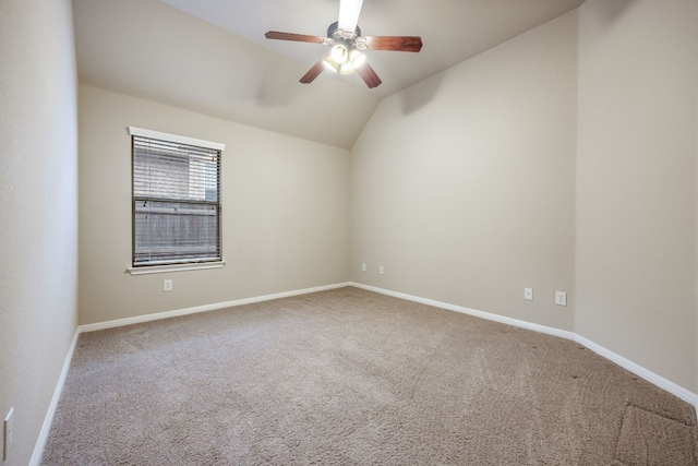 carpeted spare room featuring lofted ceiling and ceiling fan