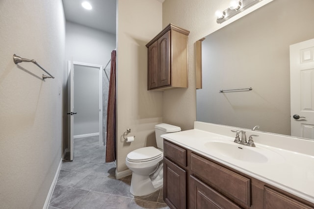 bathroom with vanity, tile patterned flooring, and toilet