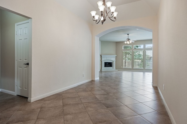 unfurnished living room with tile patterned flooring and ceiling fan with notable chandelier