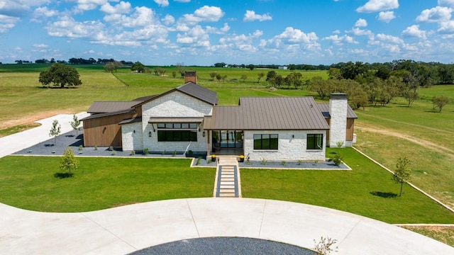 view of front facade featuring a rural view and a front yard