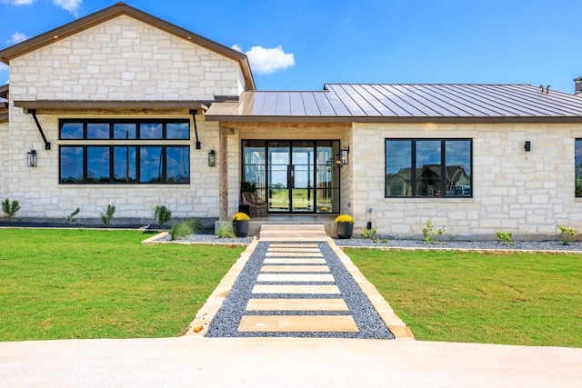1318 Country Side Bnd, Fredericksburg, TX 78624 - view of front of property featuring stone siding, a standing seam roof, a front yard, and metal roof