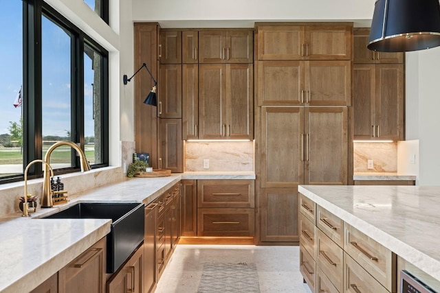 1318 Country Side Bnd, Fredericksburg, TX 78624 - kitchen with a sink, light stone countertops, and backsplash