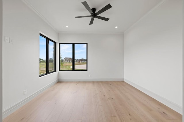 empty room with ornamental molding, light hardwood / wood-style floors, and ceiling fan