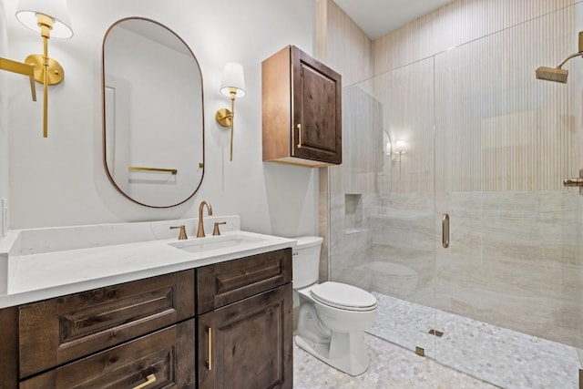 bathroom with a shower with door, vanity, and toilet