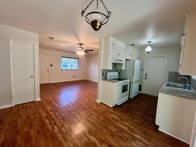 kitchen featuring dark wood-type flooring, white appliances, sink, and white cabinets